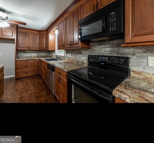 kitchen with light stone countertops, dark hardwood / wood-style flooring, ceiling fan, sink, and black appliances