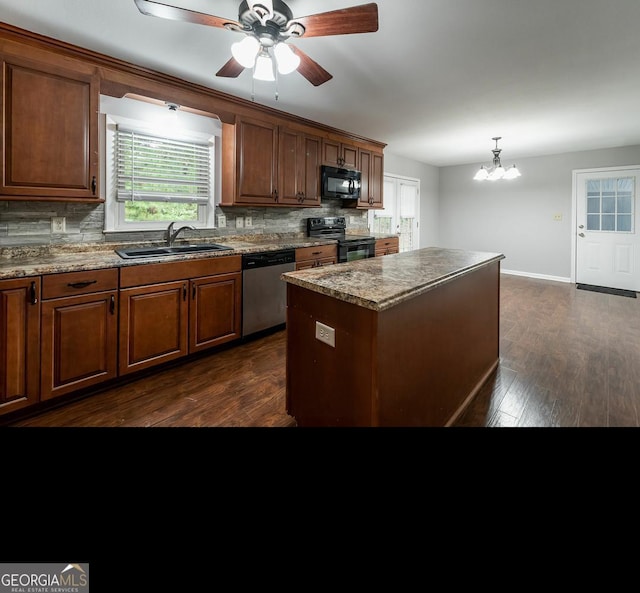 kitchen with sink, black appliances, decorative backsplash, and a kitchen island