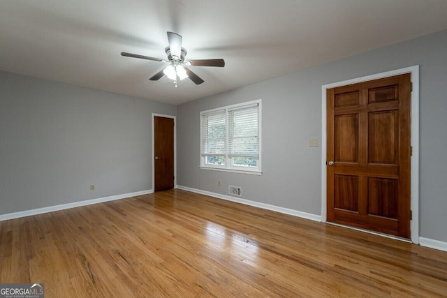 spare room featuring light hardwood / wood-style floors and ceiling fan