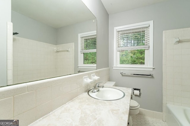 full bathroom with toilet, tasteful backsplash, bathtub / shower combination, tile patterned floors, and vanity