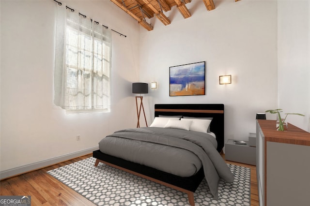 bedroom with brick ceiling, light hardwood / wood-style flooring, and vaulted ceiling with beams