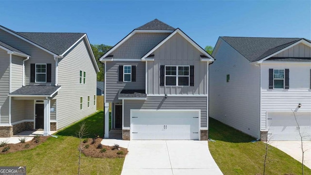 view of front of property featuring a front lawn and a garage