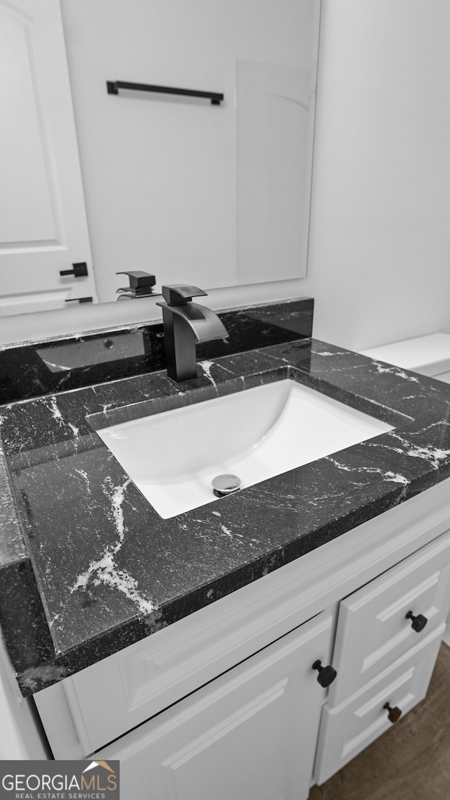 bathroom featuring hardwood / wood-style flooring and vanity