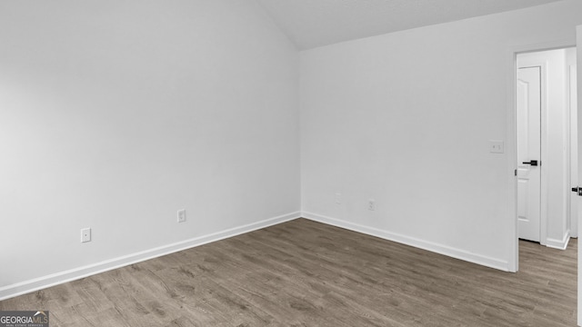 spare room with dark hardwood / wood-style flooring