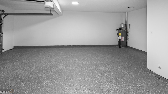 garage with electric water heater and a garage door opener