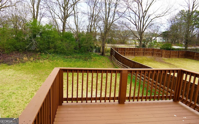 wooden terrace featuring a lawn