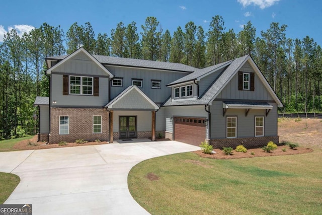 craftsman inspired home with french doors, a front lawn, and a garage