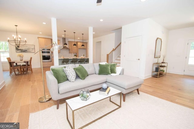 living room featuring a notable chandelier and light hardwood / wood-style floors