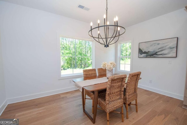 dining area featuring a wealth of natural light, a chandelier, and light hardwood / wood-style floors