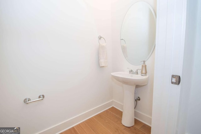 bathroom with hardwood / wood-style flooring and sink