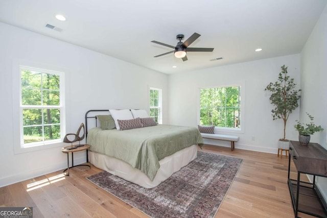 bedroom with ceiling fan and light hardwood / wood-style floors