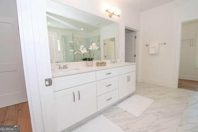 bathroom featuring vanity and a shower with door