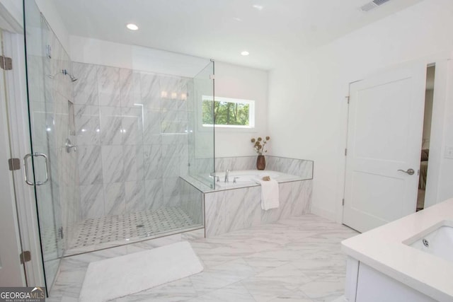 bathroom featuring vanity and separate shower and tub