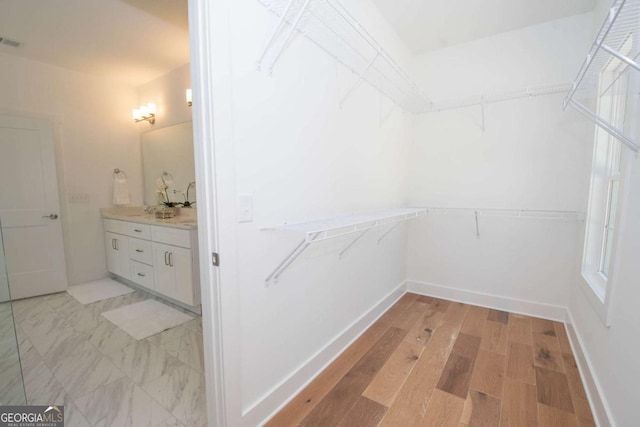 spacious closet featuring light wood-type flooring