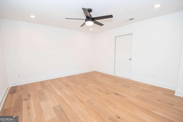 spare room with ceiling fan and light wood-type flooring