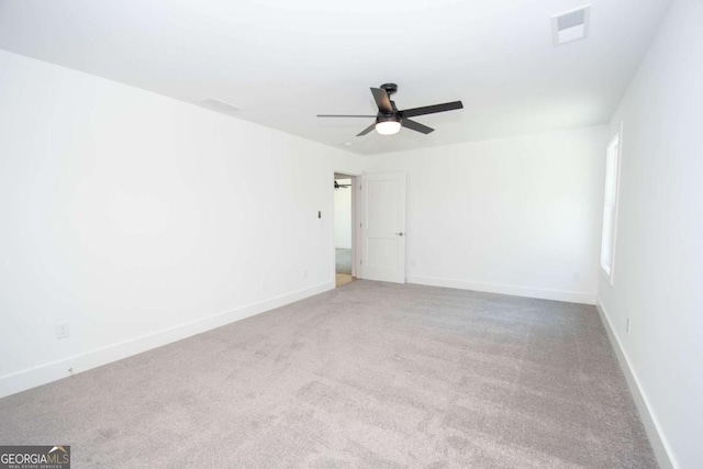 spare room featuring ceiling fan and light colored carpet