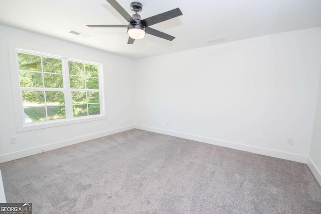 empty room with ceiling fan and carpet