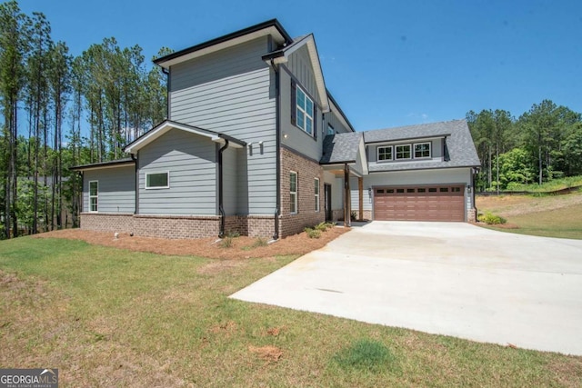 view of front of home with a front yard and a garage