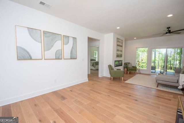 unfurnished living room with light hardwood / wood-style floors and ceiling fan