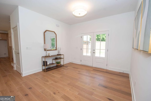 foyer entrance featuring french doors and light wood-type flooring