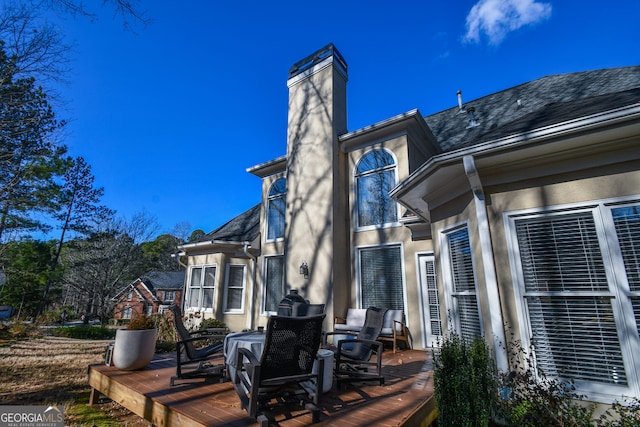 rear view of property with a wooden deck