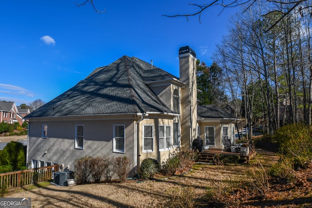 rear view of house featuring central AC