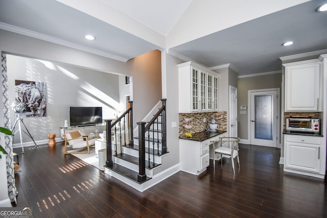 stairs featuring wood-type flooring, crown molding, and lofted ceiling