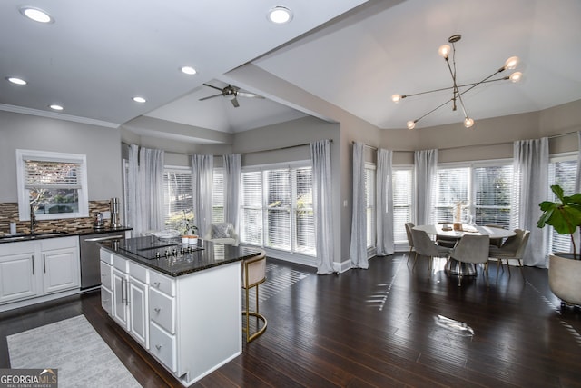 kitchen featuring dishwasher, a center island, backsplash, dark wood-type flooring, and white cabinetry