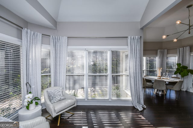 sitting room with a notable chandelier, dark hardwood / wood-style floors, and high vaulted ceiling