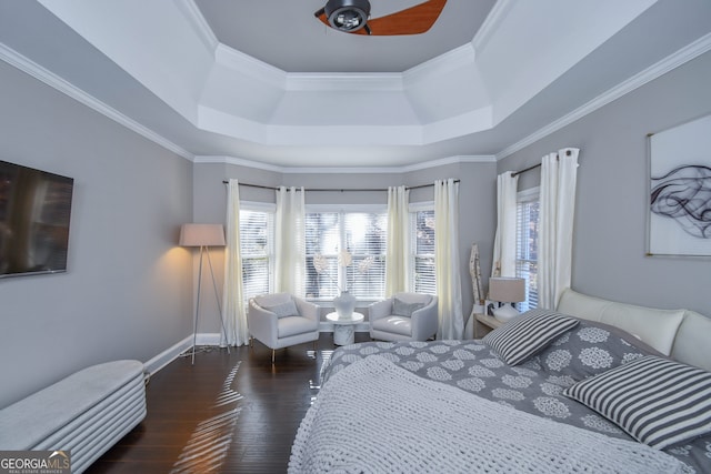 bedroom featuring a tray ceiling, ceiling fan, dark hardwood / wood-style flooring, and crown molding