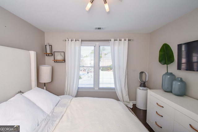 bedroom with dark hardwood / wood-style floors, multiple windows, and ceiling fan