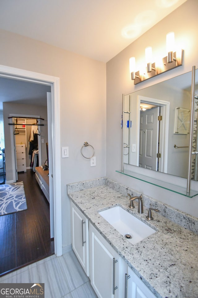 bathroom featuring vanity and wood-type flooring