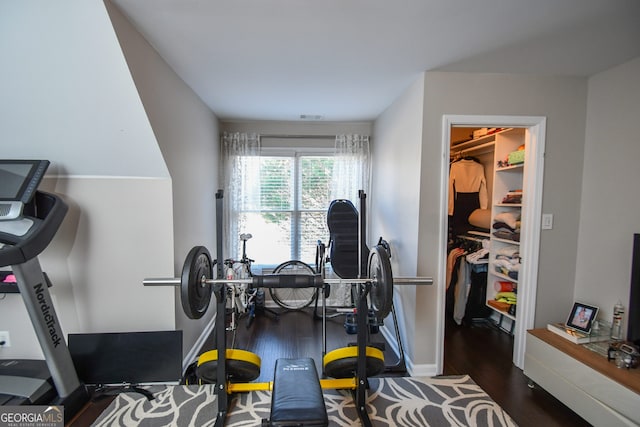 exercise area with dark hardwood / wood-style flooring