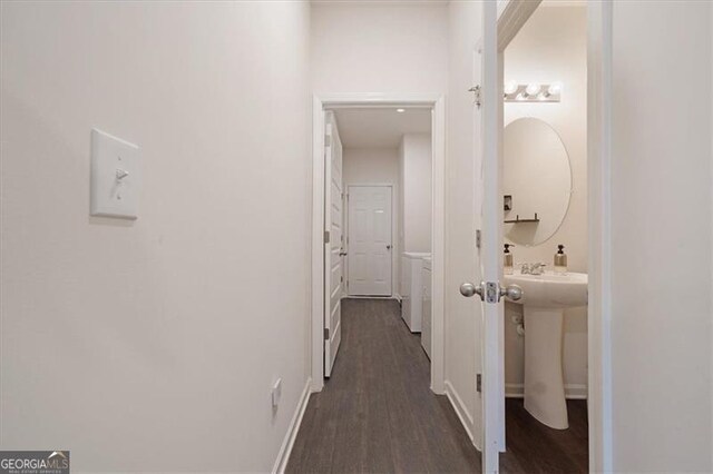 hall featuring sink and dark wood-type flooring