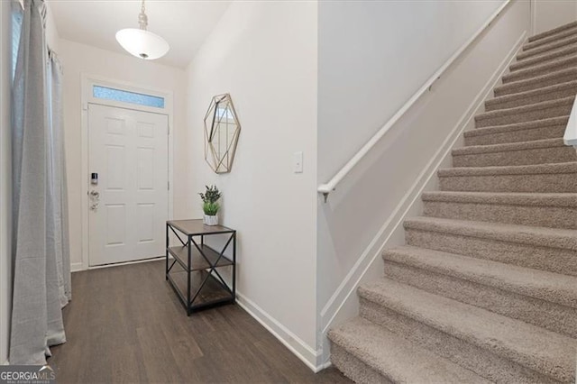 entryway with dark hardwood / wood-style floors