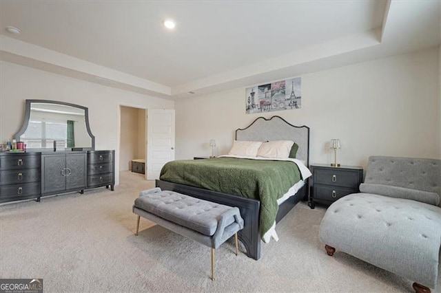 carpeted bedroom featuring a tray ceiling