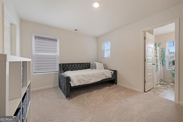 carpeted bedroom featuring ensuite bathroom