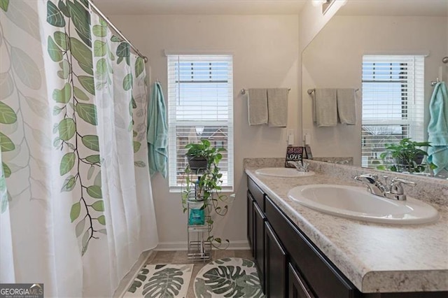 bathroom featuring tile patterned flooring, vanity, and a wealth of natural light