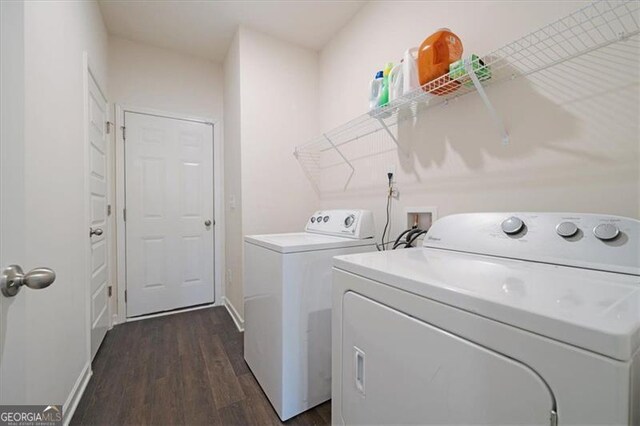 laundry area with dark hardwood / wood-style flooring and washing machine and clothes dryer