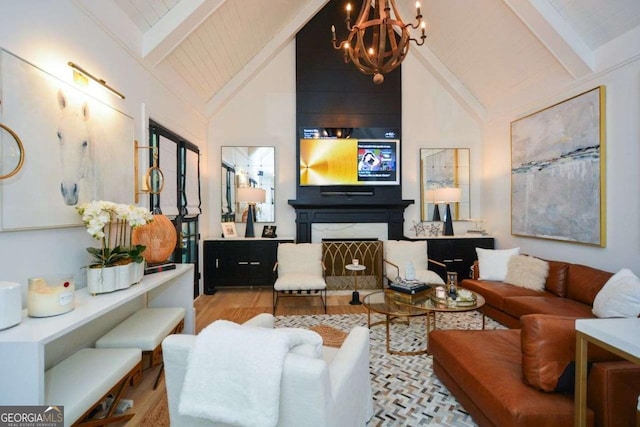 living room with light hardwood / wood-style flooring, beam ceiling, high vaulted ceiling, a notable chandelier, and a high end fireplace