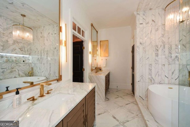 bathroom with crown molding, tile walls, an inviting chandelier, vanity, and a tub