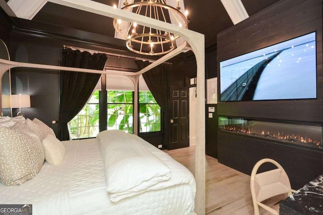 bedroom with an inviting chandelier and wood-type flooring