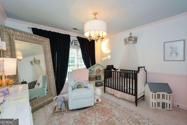 bedroom featuring a crib, ornamental molding, carpet, and a notable chandelier