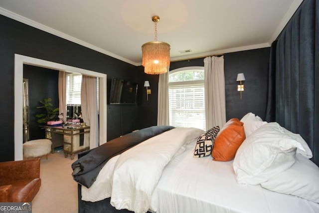 bedroom with ornamental molding and carpet flooring