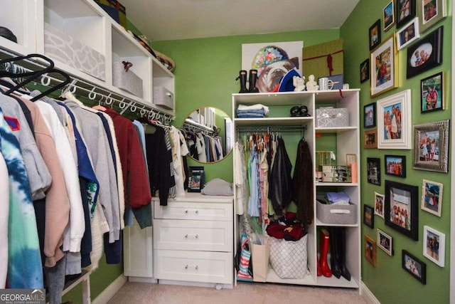 spacious closet featuring light carpet