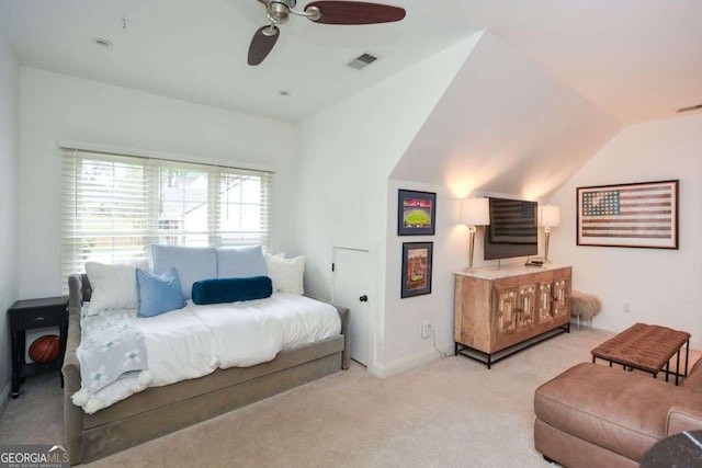 bedroom with ceiling fan, lofted ceiling, and light carpet