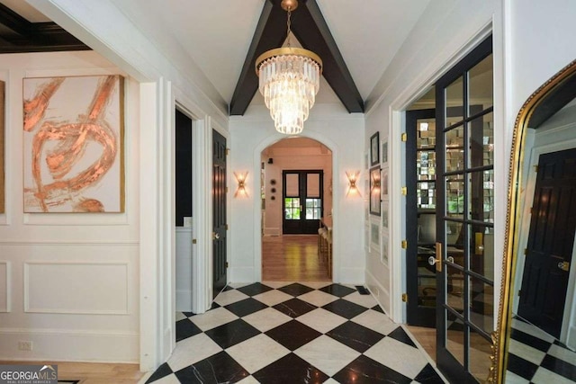 hallway featuring vaulted ceiling and a chandelier