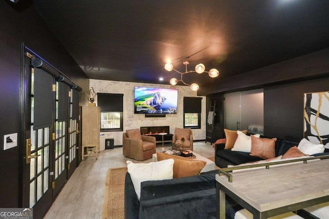 cinema room featuring light wood-type flooring and a fireplace