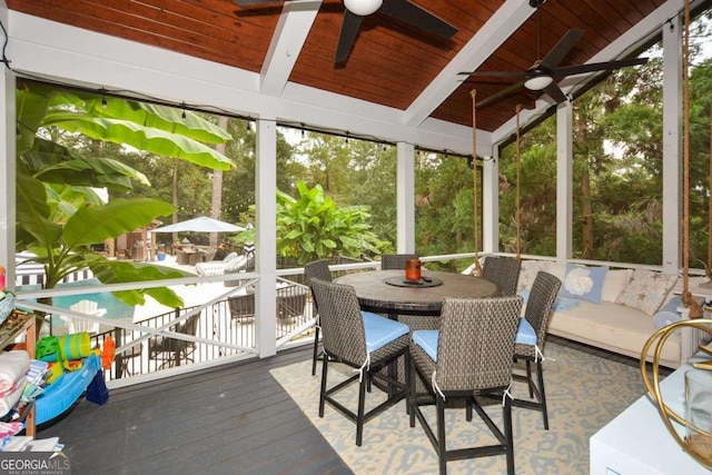 unfurnished sunroom with ceiling fan, wooden ceiling, and a healthy amount of sunlight