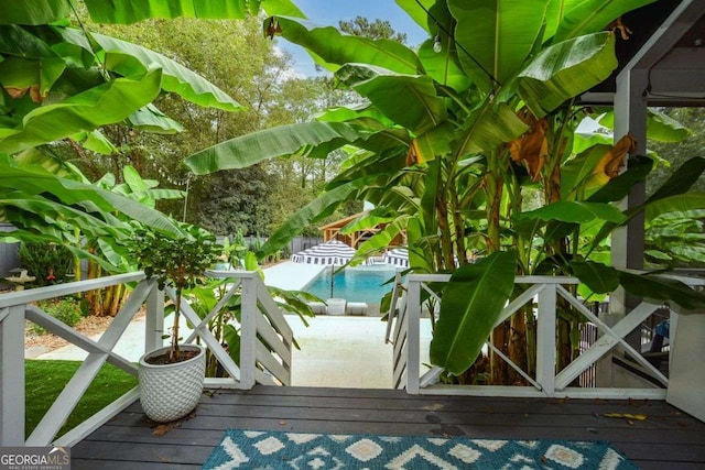 wooden balcony with a patio and a deck